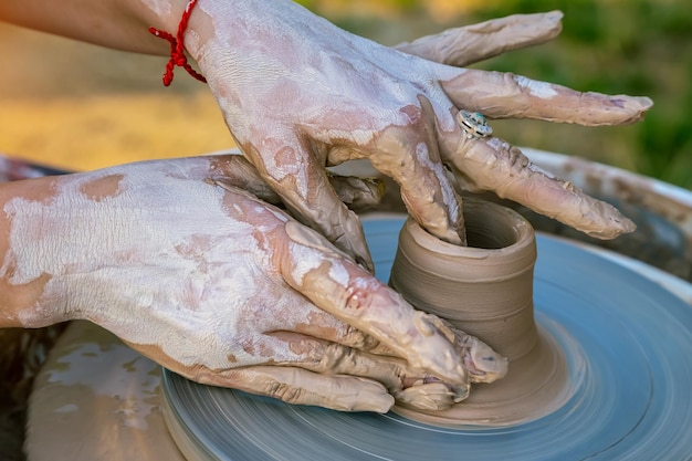 Creating a sculpture of clay closeup Hands making products from clay The sculptor at work