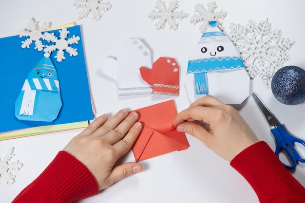 Creation of origami crafts from paper for Christmas and New Year