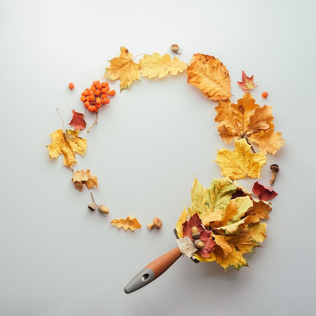 Creative autumn wreath of leaves on a gray background. Autumn leaf composition with copy space.