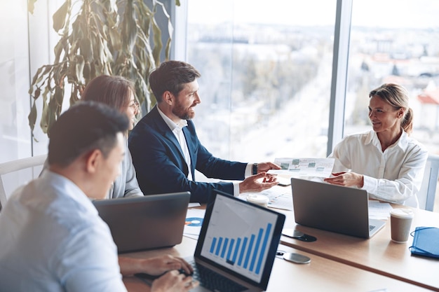 Creative business people working on business project in modern office with panoramic view