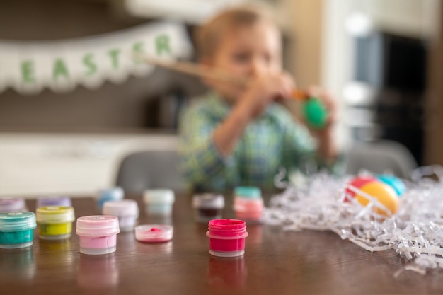 Creative child working on Easter egg decoration