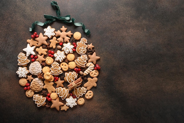 Creative Christmas bauble of homemade cookies cranberries on brown background