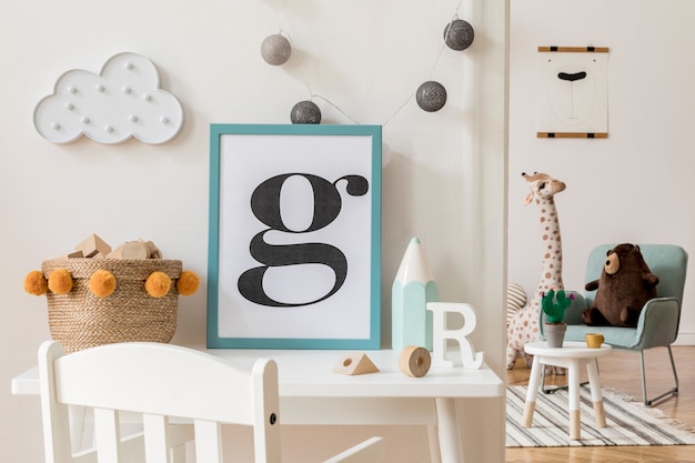 Creative composition of stylish and cozy child room interior with picture frame, toys and plush toys, white furniture and accessories