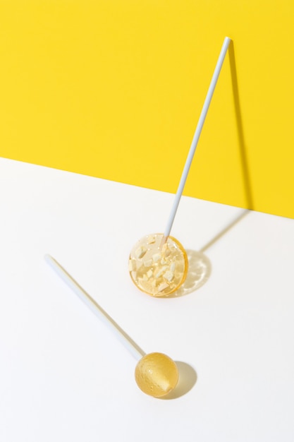 Creative composition with lollipop made from natural dehydrated mango