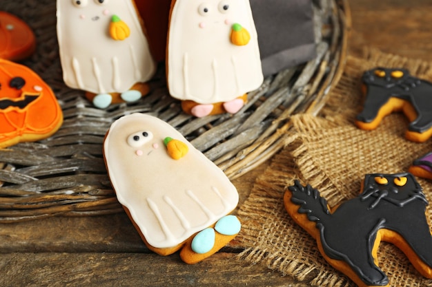 Creative cookies for Halloween party on wicker plate