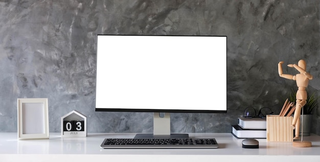 Creative designer desktop with blank white laptop screen with mockup poster on white desk