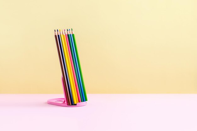 Creative education concept Pencils on pink yellow background