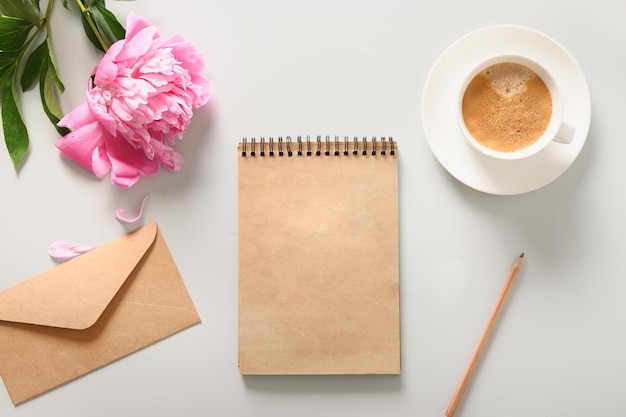 Creative female mockup with coffee cup peony flowers sketchbook for planning