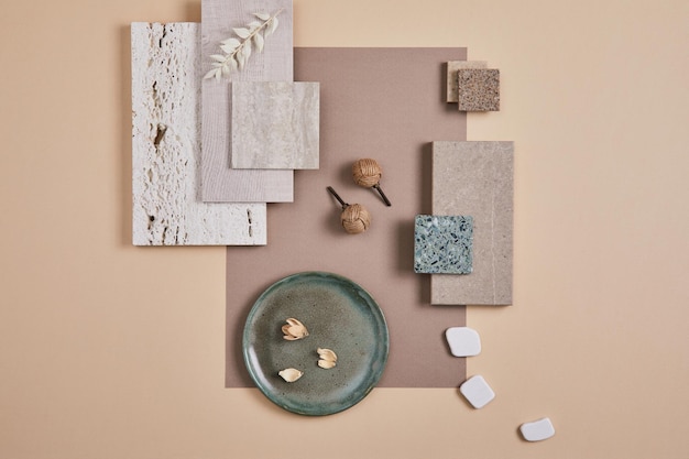 Creative flat lay composition of interior designer moodboard with textile and paint samples panels and cement tiles Beige grey and green color palette Copy space Template