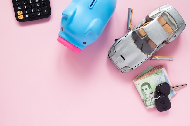 Creative flat lay of finance or car loan concept with Thai banknotes on pink background