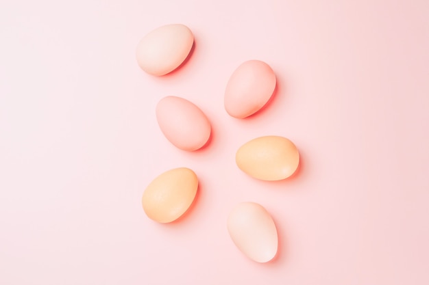 Creative flat lay photo of easter eggs on colorful background.