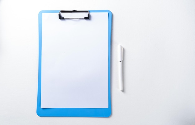 Creative flat lay photo with clip board and pen on desk mock up