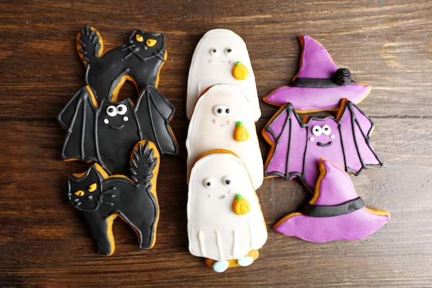 Creative Halloween cookies on wooden background