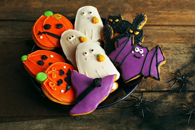 Creative Halloween cookies on wooden background