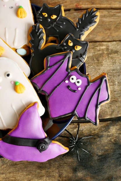 Creative Halloween cookies on wooden background