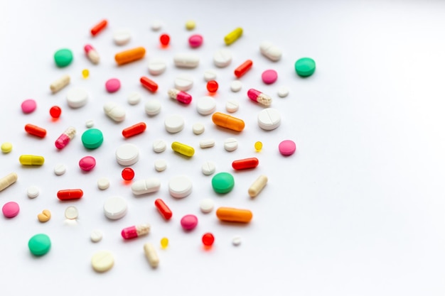 Creative layout of colorful pills and capsules on green background Minimal medical concept Pharmaceutical Covid19 Flat layMedication and prescription pills Virus epidemic