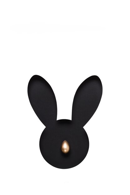 Creative layout made of black Hole rabbit head with golden egg nose. Happy easter minimal concept.