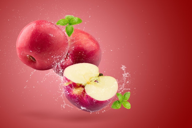 Creative layout made from Fresh Red Apple fruit and water Splashing on a red background