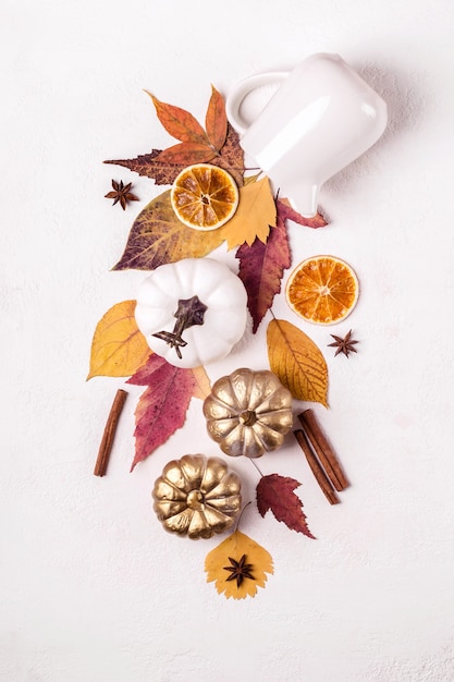 Creative layout made of golden pumpkins and leaves. Autumn floral composition.