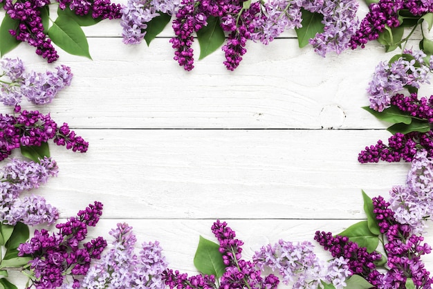 Creative layout made with spring lilac flowers on white wooden background. Flat lay. top view