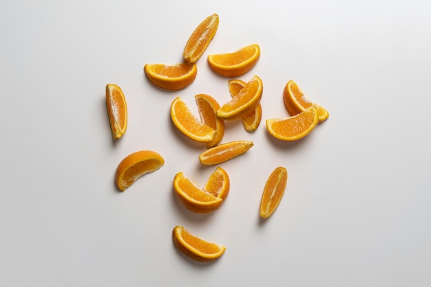 A creative layout of orange fruit slices on white surface