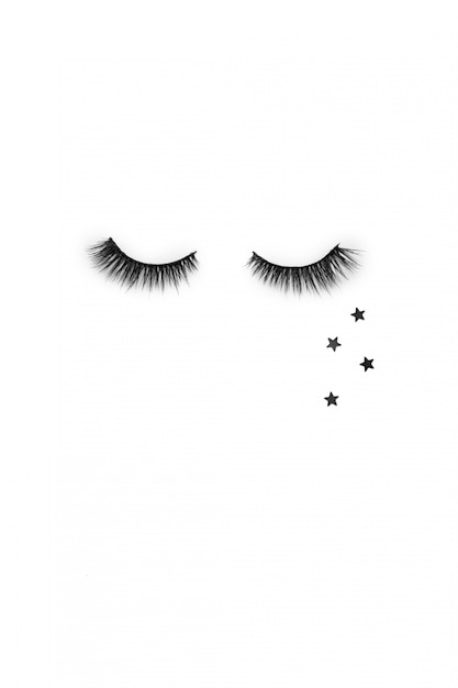 Creative layout with eyelashes. Closed eyes on white background