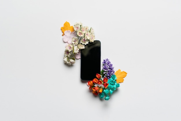 A creative layout with smartphone template mockup design and flowers around