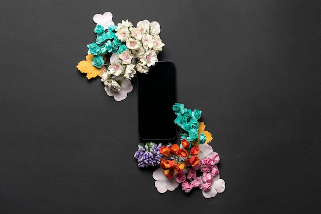 A creative layout with smartphone template mockup design and flowers around