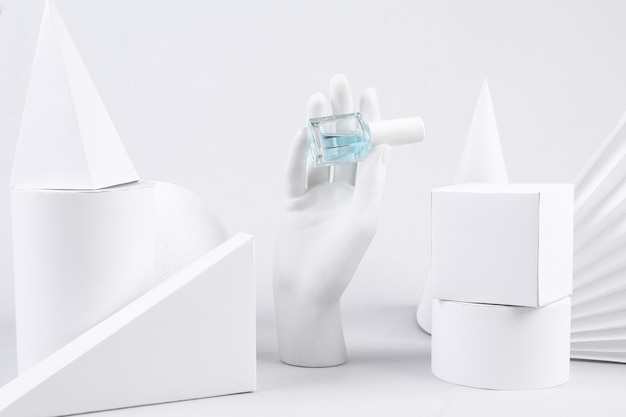 Creative minimalism showcase Hand holds a bottle of nail polish geometric shapes on a white background Concept art Beauty and fashion