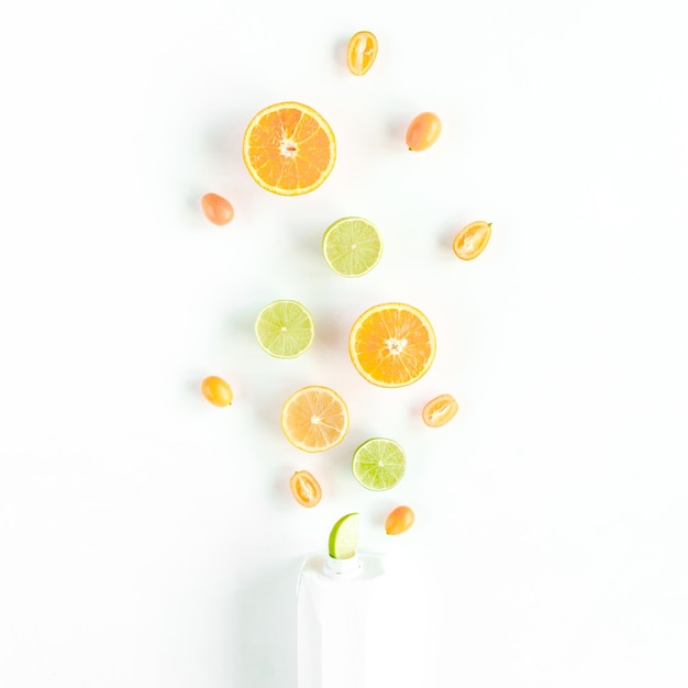 Creative pattern made of summer tropical fruits orange lemon lime food concept flat lay top view