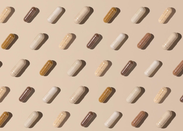 Creative pattern with capsules on light beige top view hard shadows Taking supplements