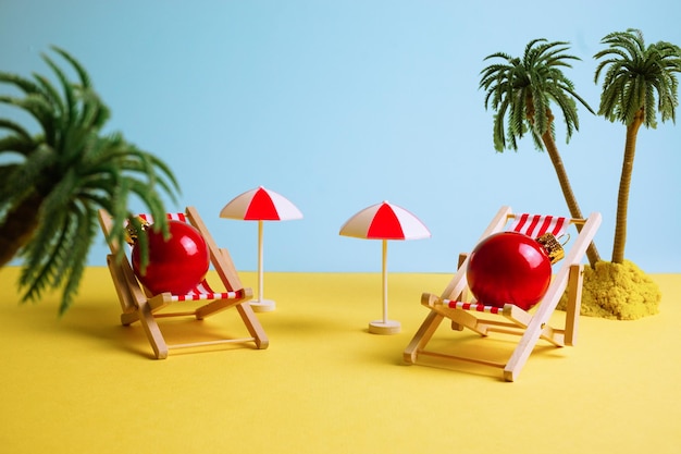 Creative photo of red Christmas balls resting on the beach