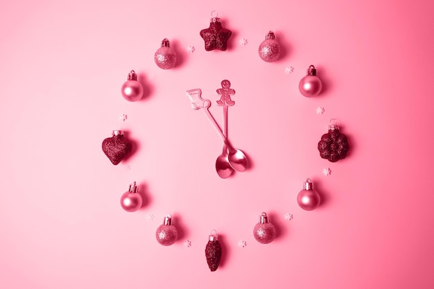 Creative photo with Christmas toys in the form of a clock face in the color of the year 2023