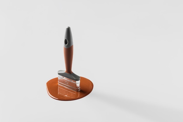 Creative renovation concept Paintbrush melts in brown paint on a gray background with copy space