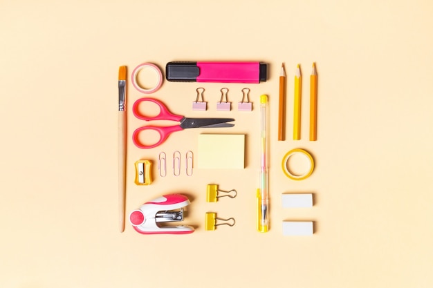 Creative school or office supplies on yellow background. Concept back to school