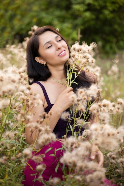 A creative sensual portrait of a young beautiful brunette woman surrounded by plants Alone with nature Lifestyle