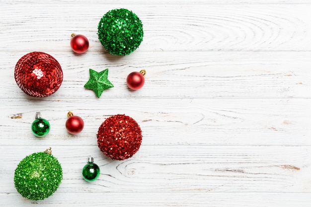 Creative set of New Year baubles and decorations on wooden background. Top view of Christmas time concept. Copy space