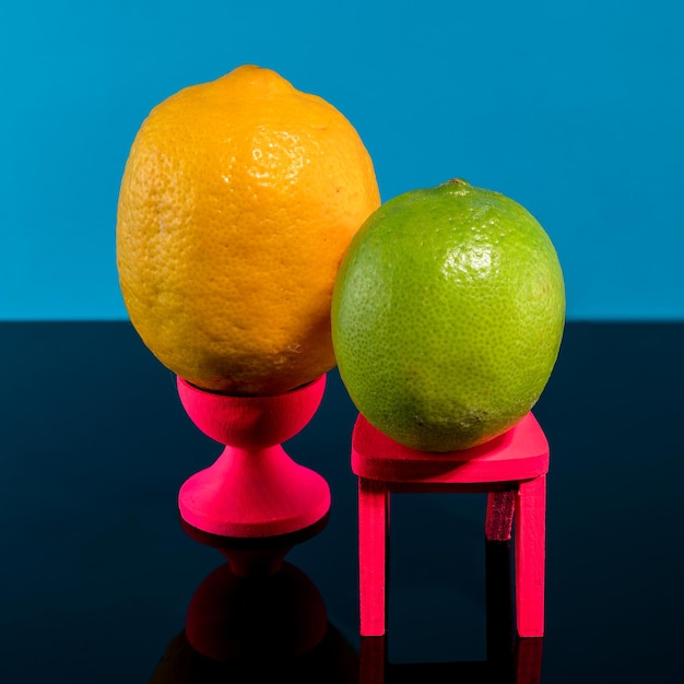 Creative still life with lemon and lime on a blue background