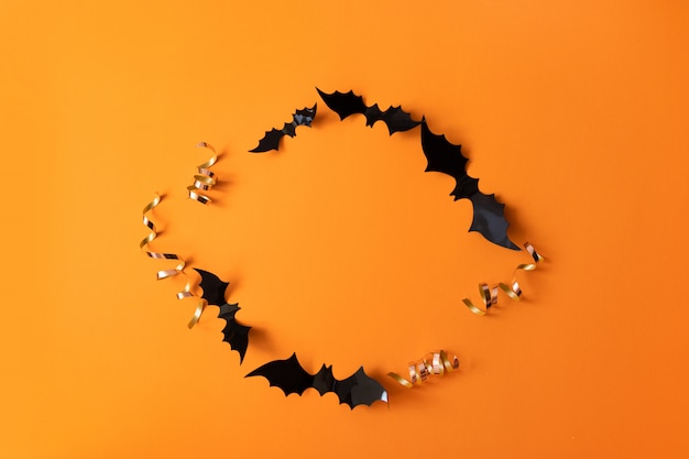 Creative top view flat lay autumn Halloween composition of black paper bats frame