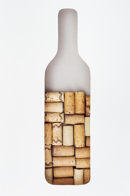 Creative wine bottle with wooden corks inside Form of bottle in front on paper background