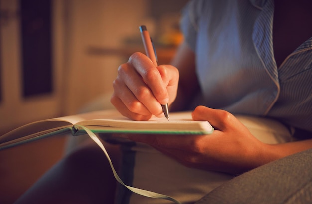 Creative writing at home by female hands enjoying a calm peaceful day off indoors Woman making notes in a journal expressing her feelings and thoughts while making a note of a personal experience