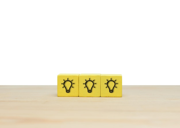 Creativity and innovation light bulb icon on wooden cubes for idea concept