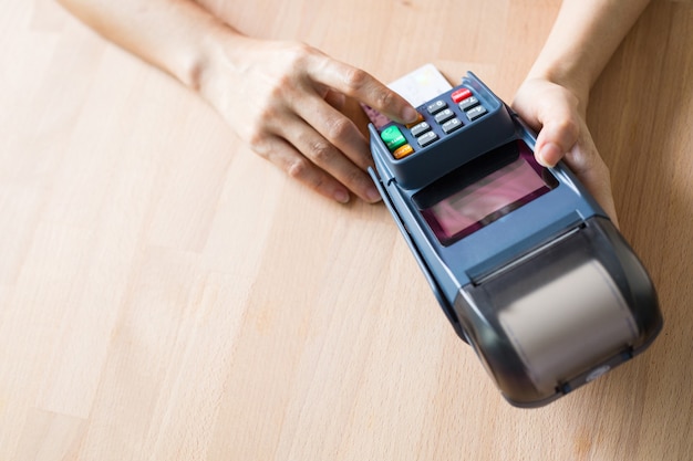 Credit card machine holding for payment from customer in Department store.