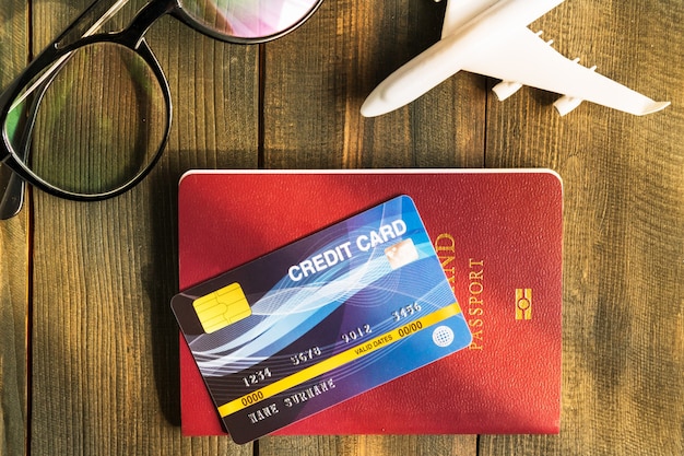 Credit card put on passport on wooden desk , Preparation for Traveling concept