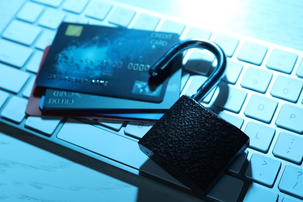 Credit cards lock and computer keyboard on table closeup Cyber crime