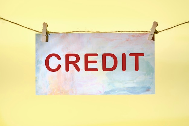 Credit text on colored paper hanging on a rope with clothespins