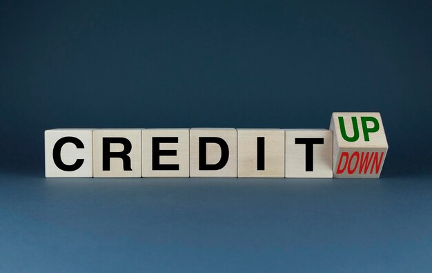 Credit up or down Cubes form words Credit up or Credit down Conceptual image of finance and banking