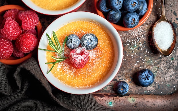 Creme brulee (cream brulee, burnt cream)  with raspberries and blueberries