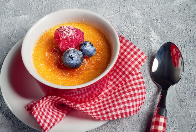 Creme brulee with raspberry and blueberry