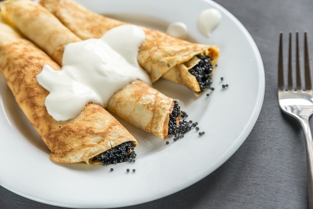 Crepes with black caviar